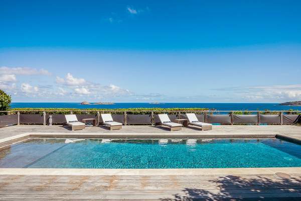 Lounge poolside and enjoy amazing ocean views from Claridge Villa