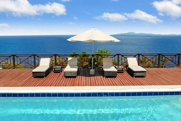 Lounge by the pool with the ocean as your background at Panorama