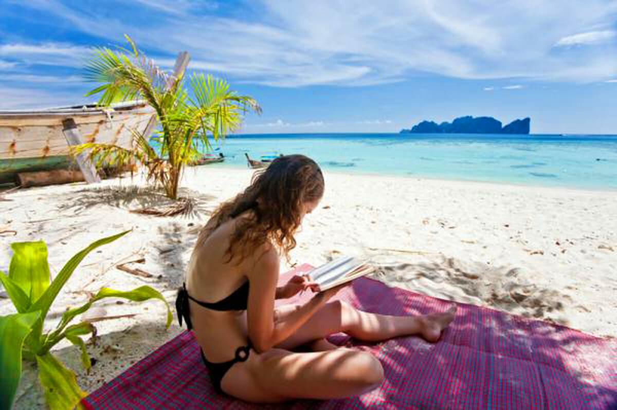 woman reading on Caribbean beach